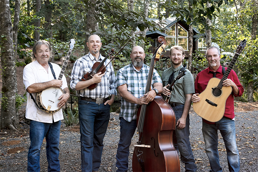 Five-piece band stands with their instruments