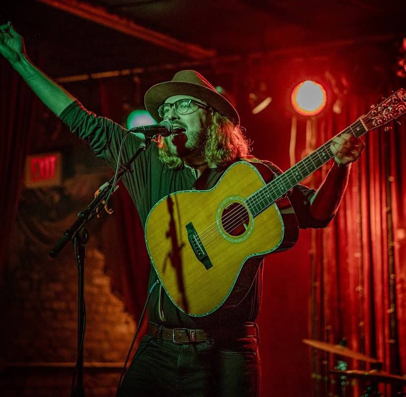 man with guitar onstage