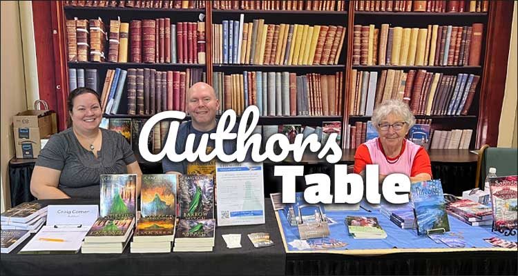 people sitting at table with books on and behind the table